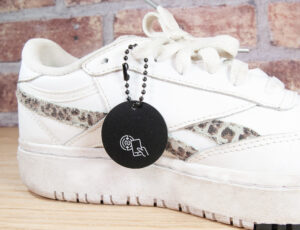 A white trainer with a black tag on from P&P LIVE!