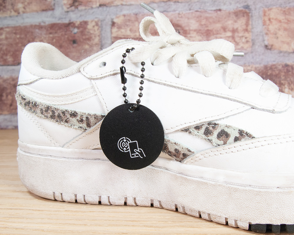 A white trainer with a black tag on from P&P LIVE!