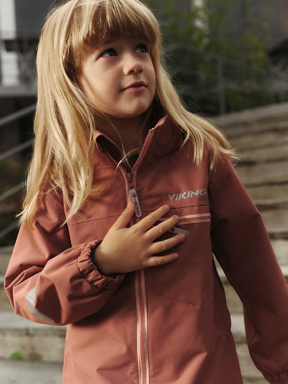 A young girl walking down a set of steps