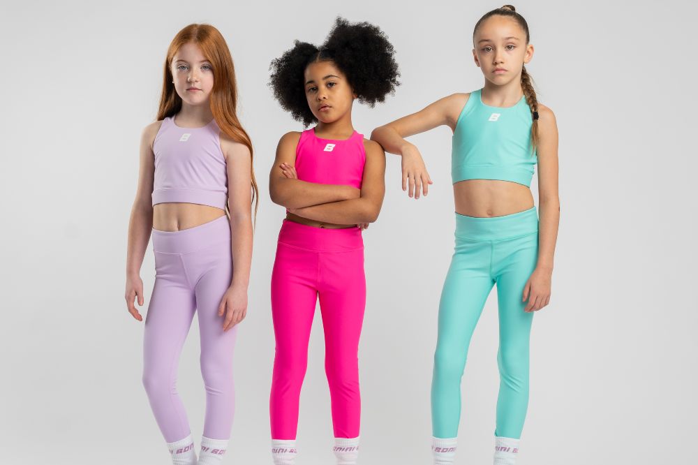 Three girls stood together wearing Bonini activewear