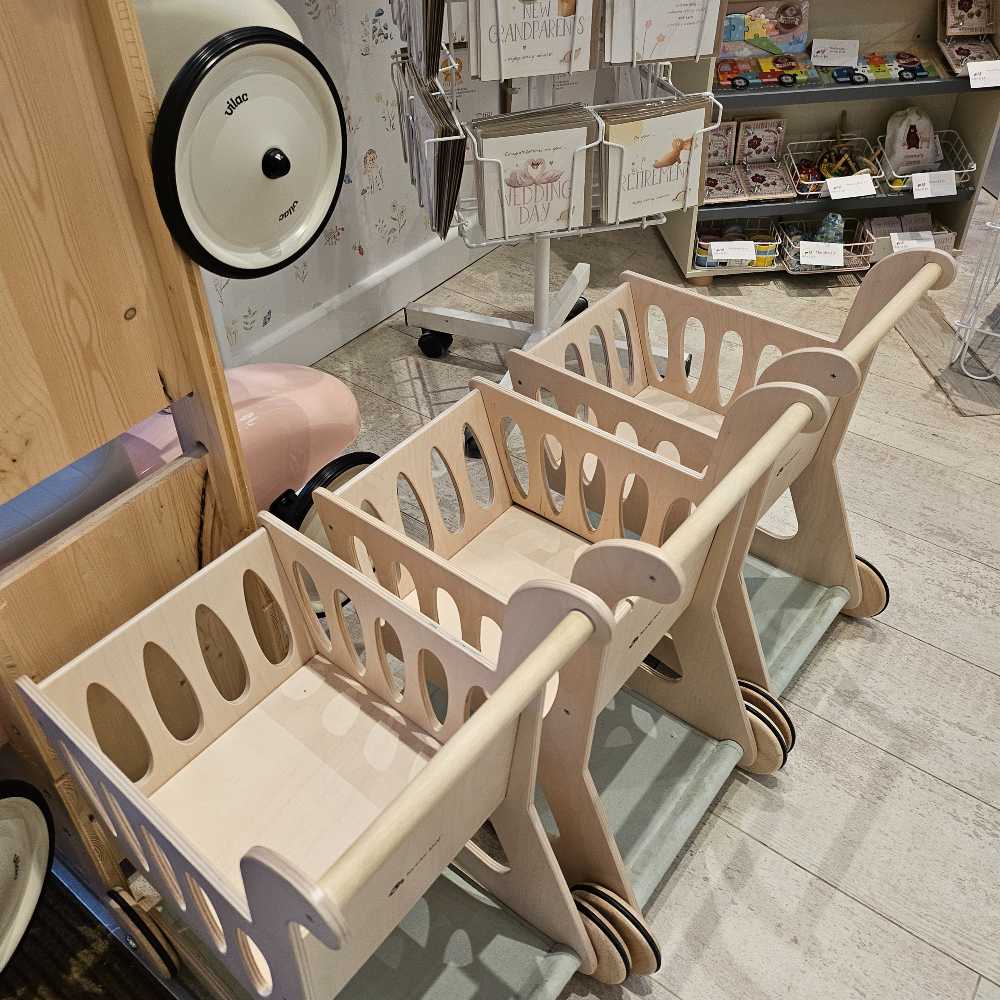 Children's wooden shopping carts lined up in a the Hettie & Sid store 