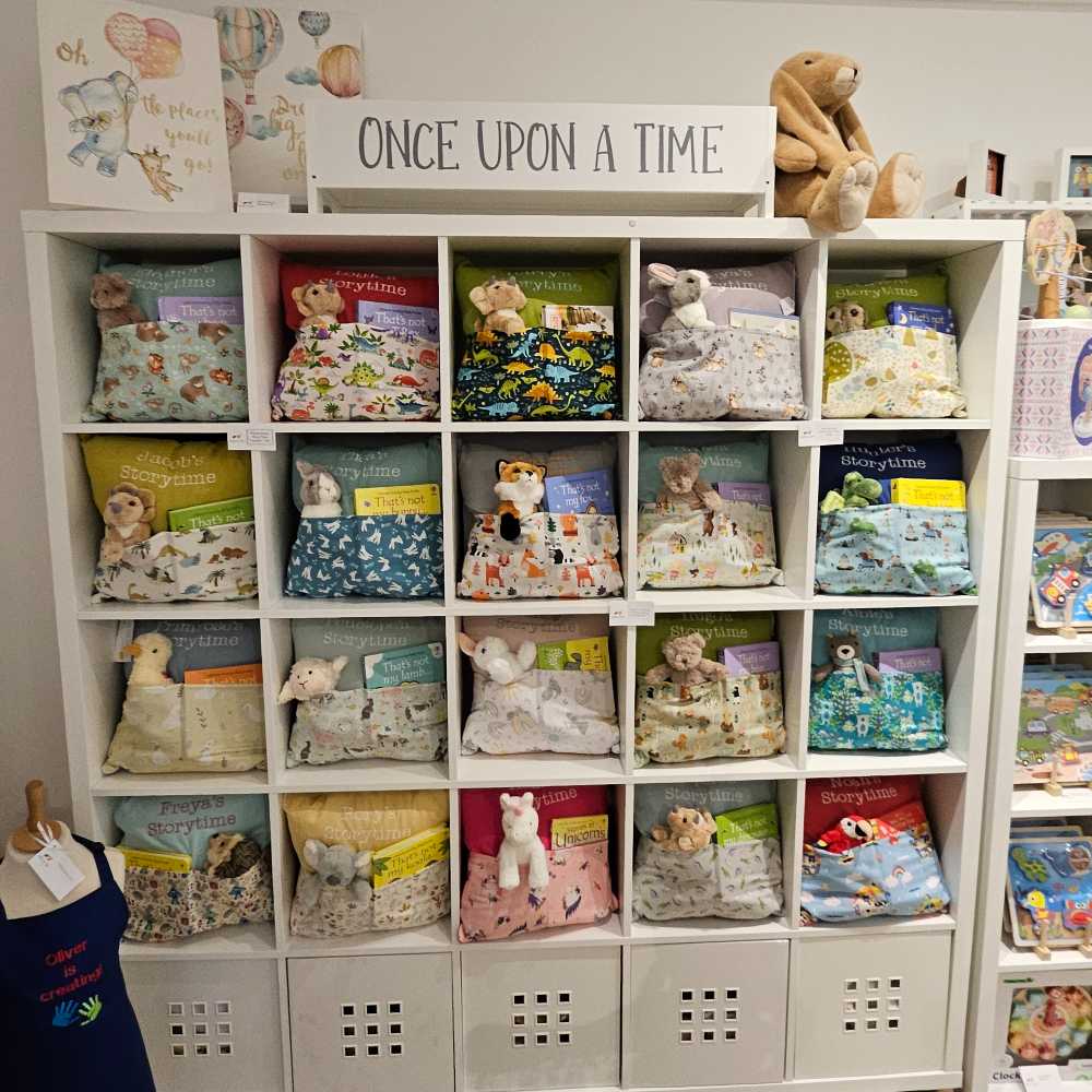 Children's Fabric Bug personalised cushions displayed on shelves in the Hettie & Sid store 