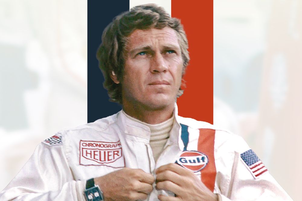 Steve McQueen pictured in a racing jacket in front of blue, white and red lines