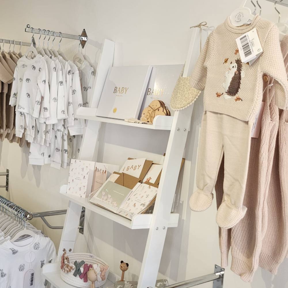 Baby clothes and accessories displayed inside the Pops & Flo store