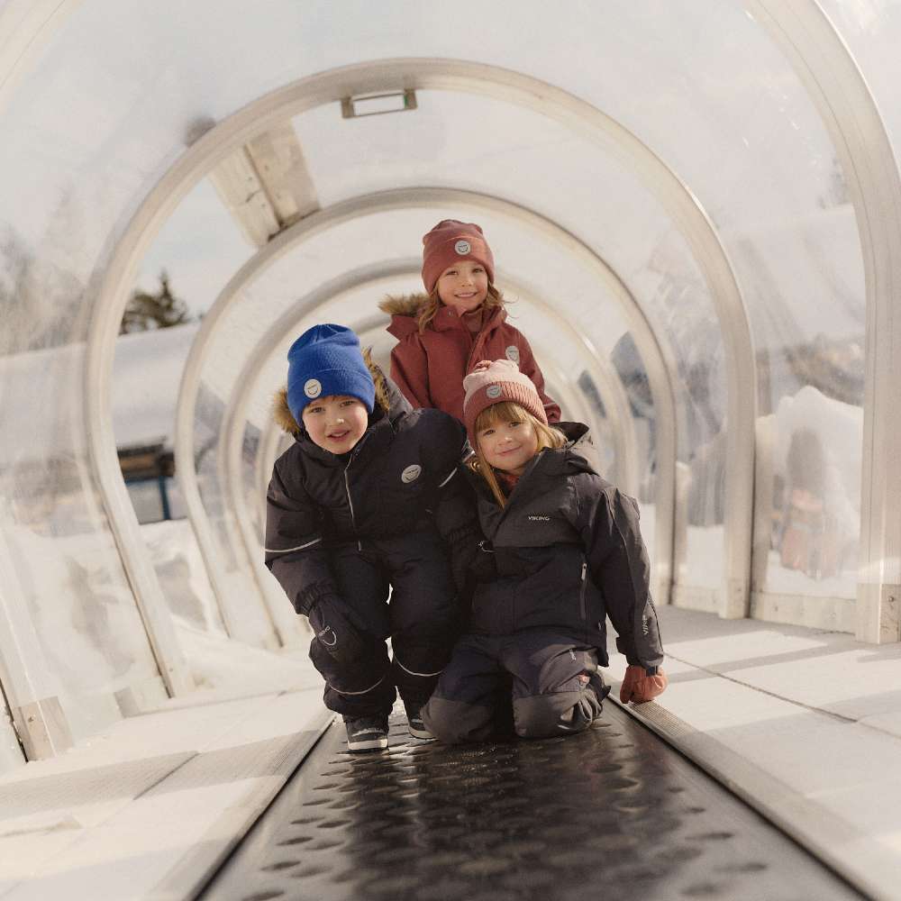 Three children wearing outdoor clothing 