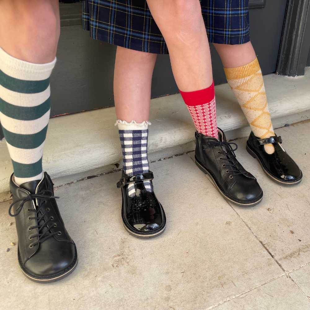 Children's legs wearing bright socks and school shoes by Young Soles 