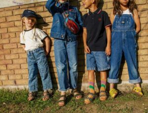 Four children stood outside against a wall