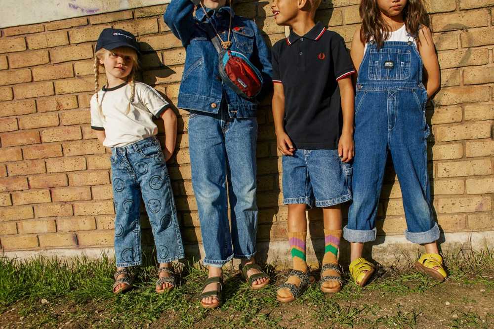 Four children stood outside against a wall