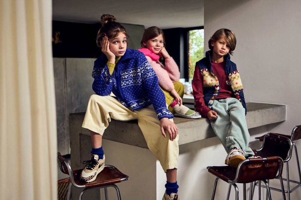 Three children sat on a kitchen worktop