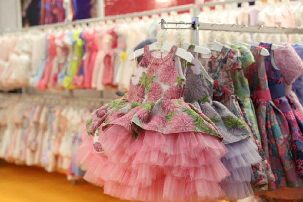 Special occasion girls' dresses displayed on a stand at the IFCO Istanbul Fashion Connection trade show