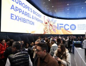 A large group of people gathered at the registration desk of IFCO Istanbul Fashion Connection