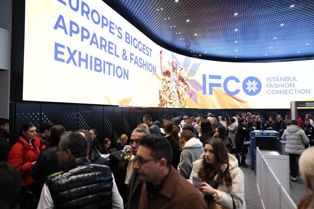 A large group of people gathered at the registration desk of IFCO Istanbul Fashion Connection