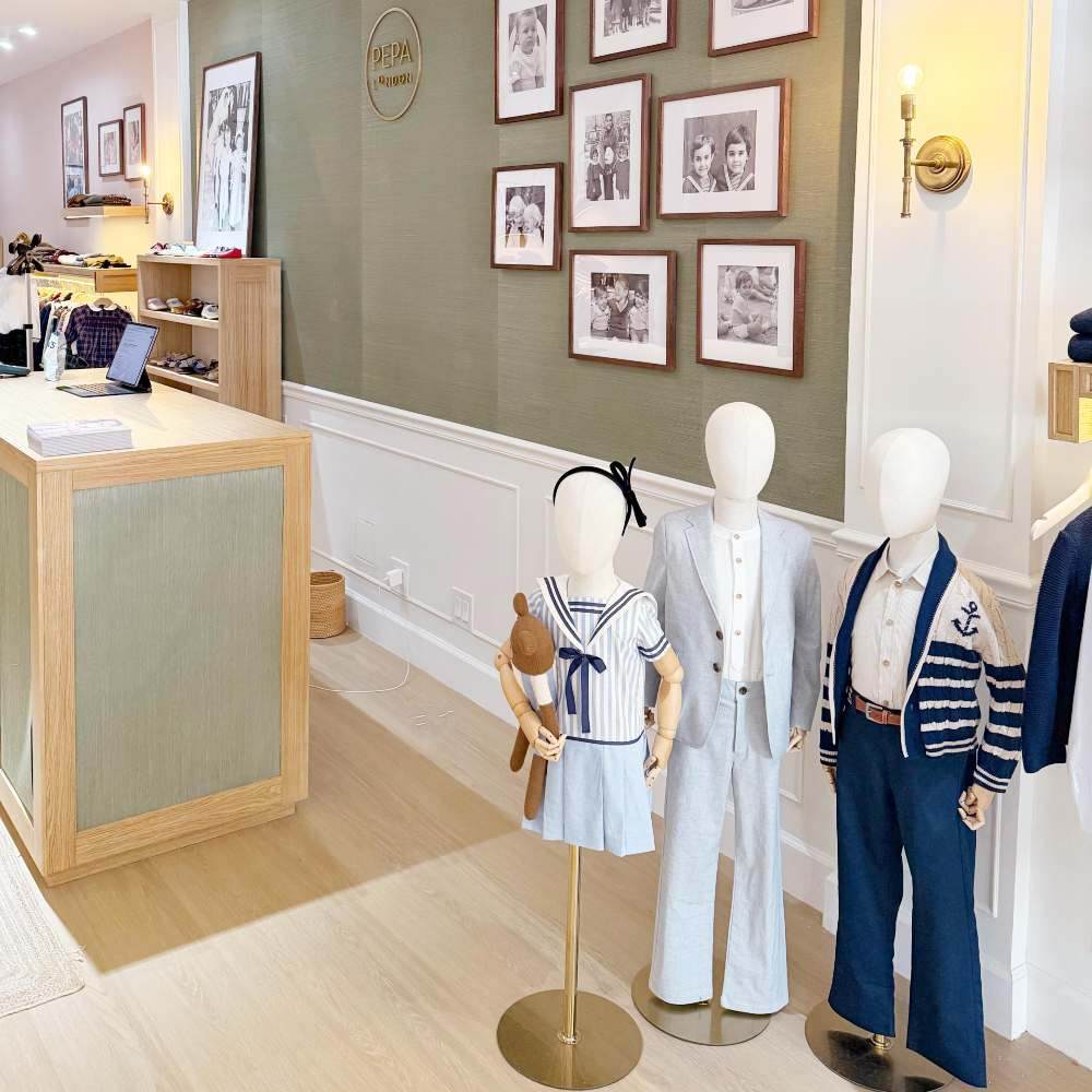 Three children's mannequins displayed next to a cashier desk in the new US Pepa London store 