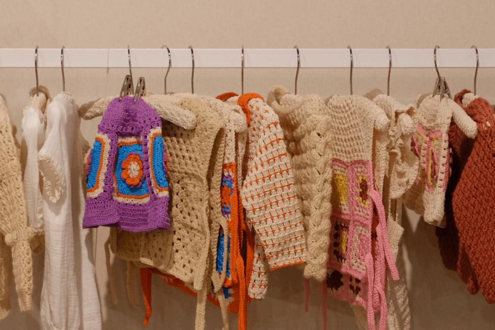 A rail of children's crochet clothing items