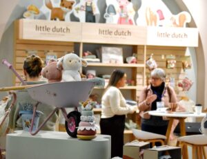 People stood on the Little Dutch stand displaying children's toys and accessories at Harrogate International Nursery Fair