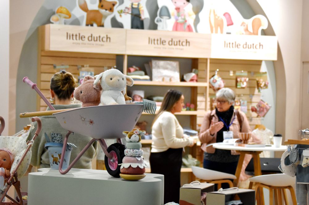 People stood on the Little Dutch stand displaying children's toys and accessories at Harrogate International Nursery Fair