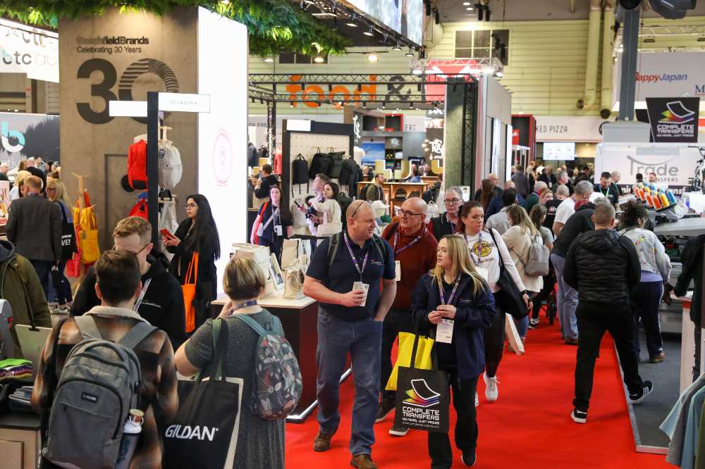 A busy exhibition hall showing stands and people at Printwear & Promotion LIVE! 2025