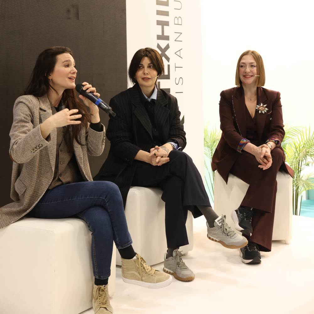 Three woman sat on a stage talking at Texhibition 