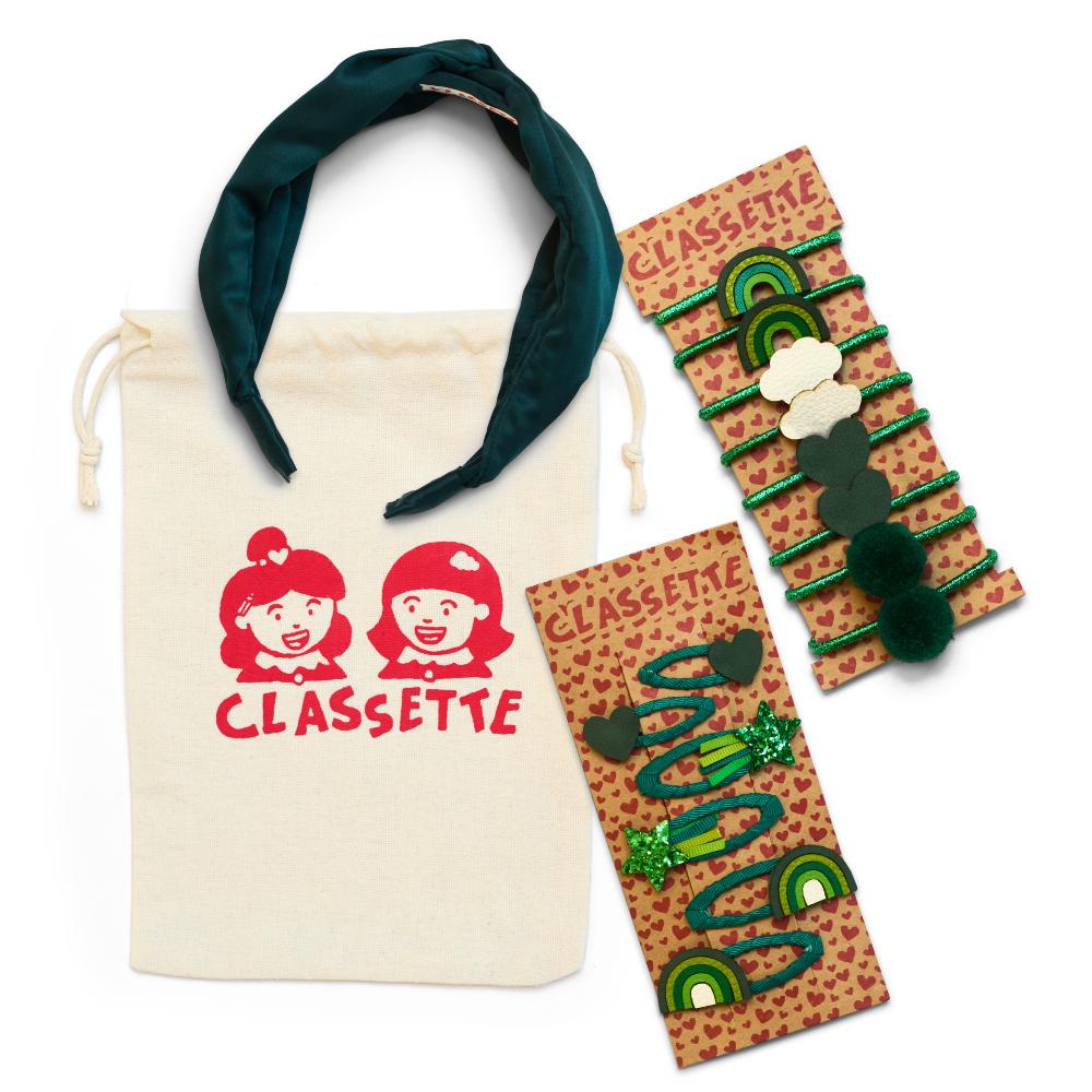 A green set of children's school hair accessories displayed with a bag with Classette Kids on the front 
