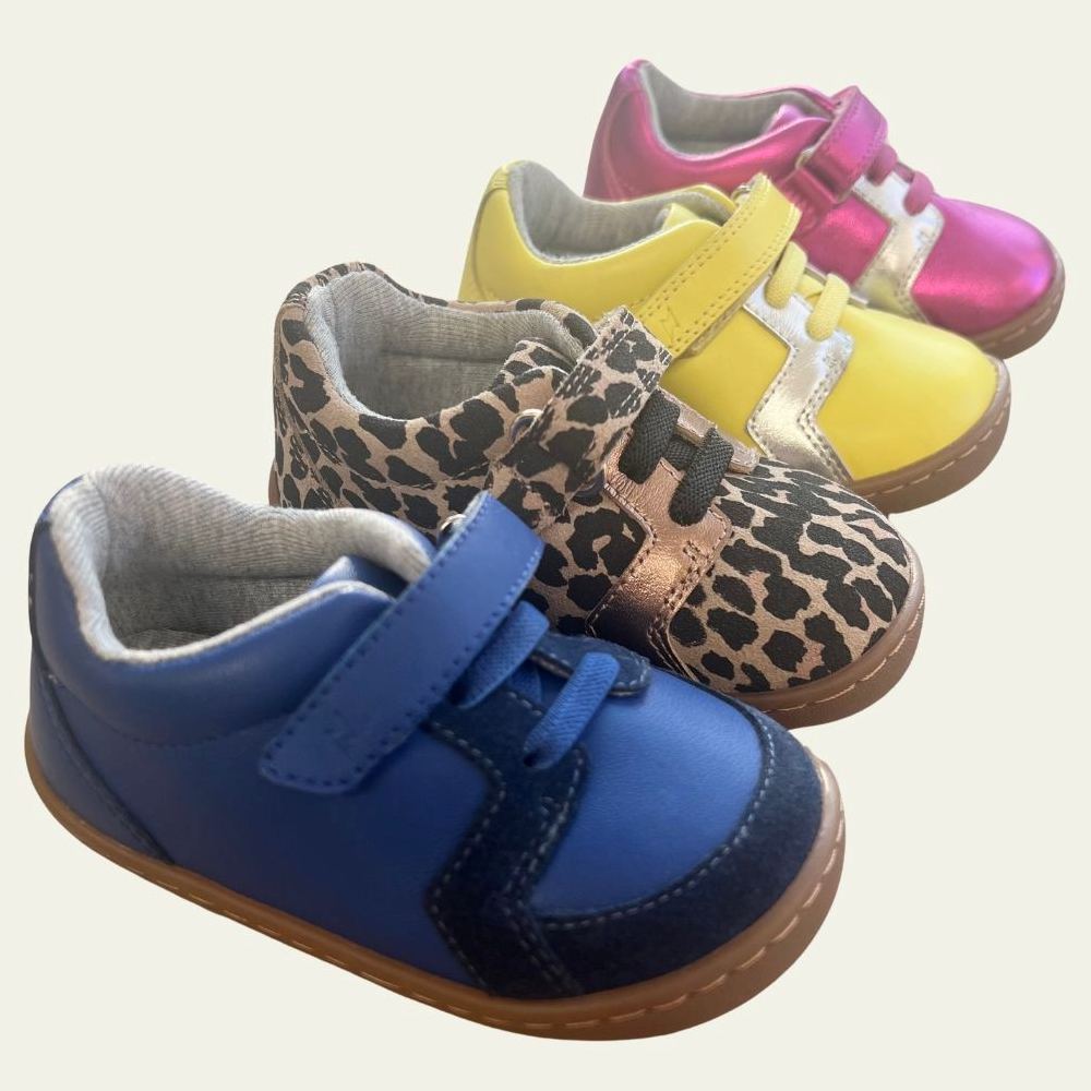 Brightly coloured children's shoes displayed in a row 