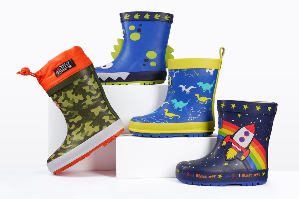 Four brightly coloured children's wellies by ToeZone displayed on a stand 