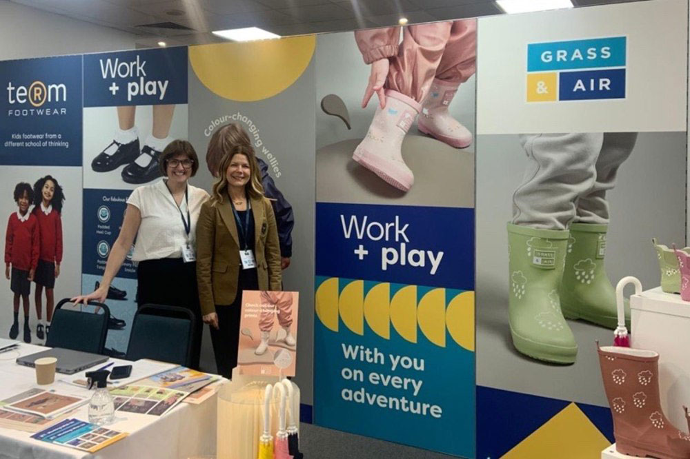 Two colleagues stood on a Term Footwear exhibition stand