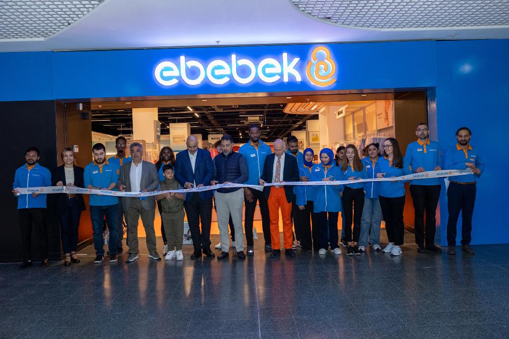 A group of people cutting a ribbon outside a new Ebebek store