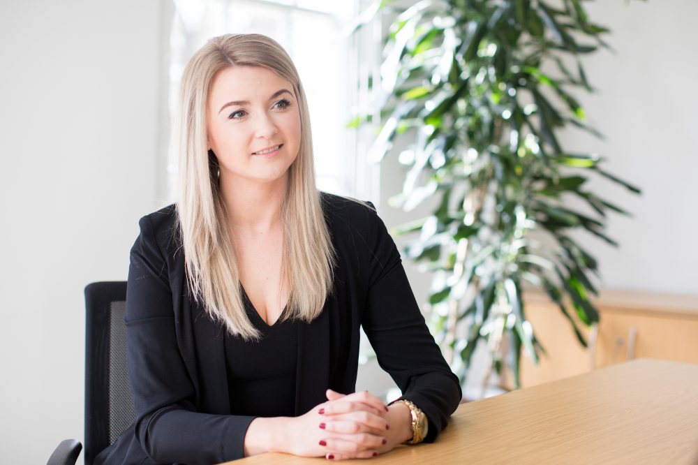 Kate Hallifax of HCR Law sat at a desk