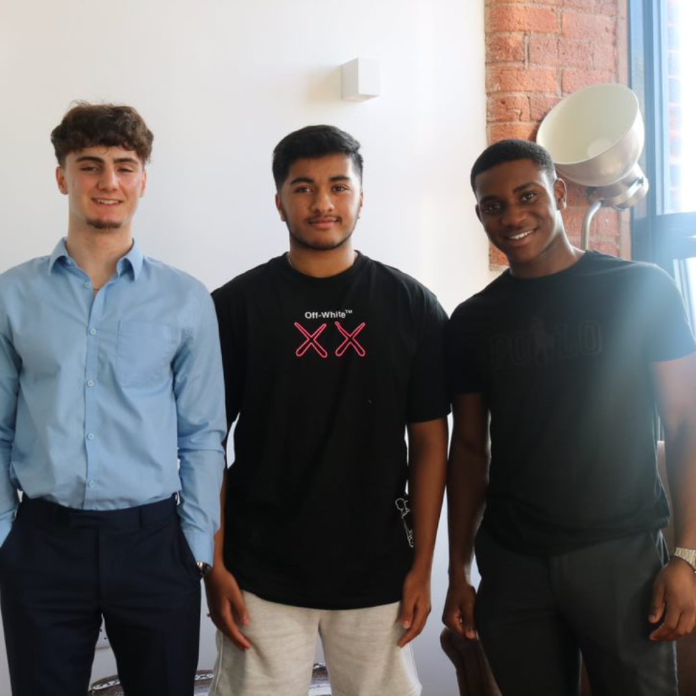 Students stood with a tutor from Spark Tutoring 