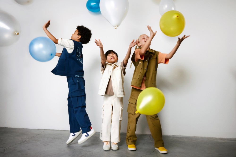 Three children playing with balloons