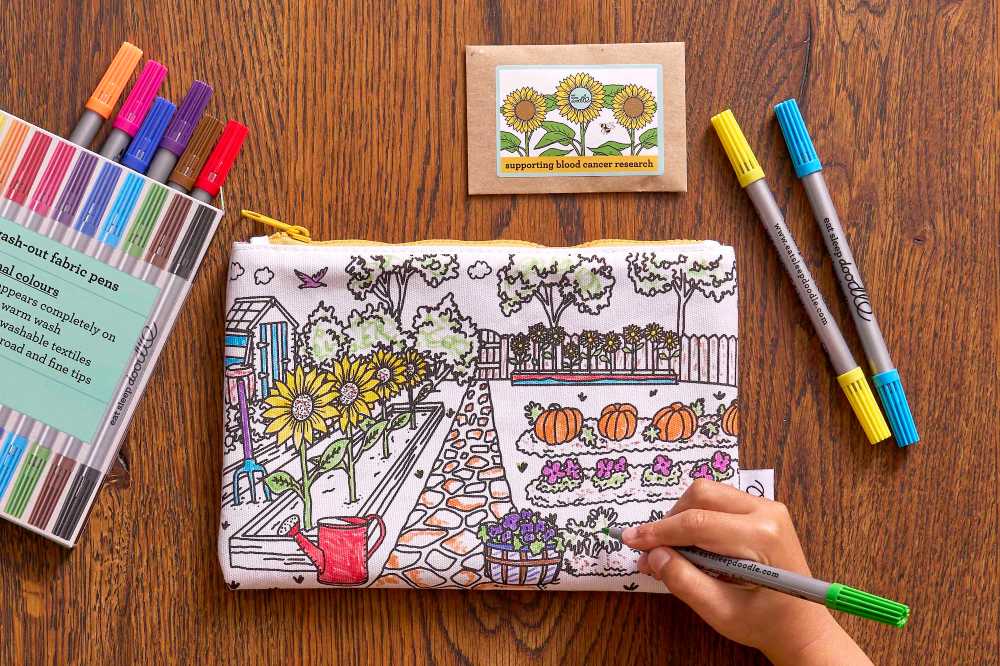 A child at a desk colouring in the new colour-in & grow sunflower pencil in support of Beth's Sunflowers