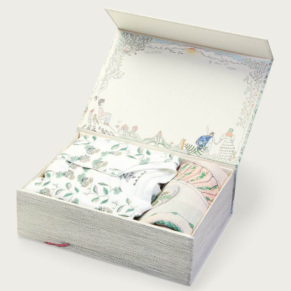 A gift box containing including a baby muslin, babygro, baby bib and hat
