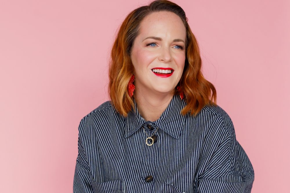 Head shot of Jill Zendera, founder of Trendology, against a pink background