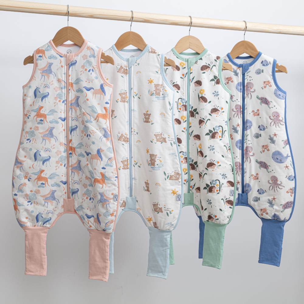 Children's sleepwear hung on a wooden rail 