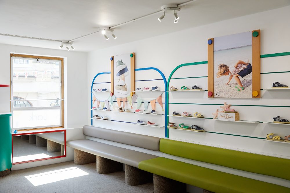 Children's shoes displayed on a wall in Lark Kids children's shoe shop