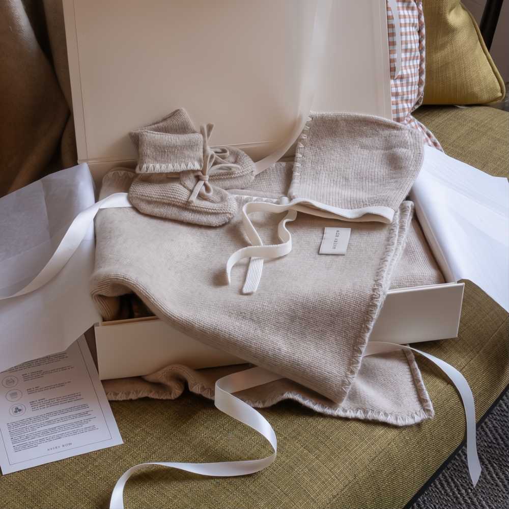 A cashmere baby gift set displayed in a gift box 