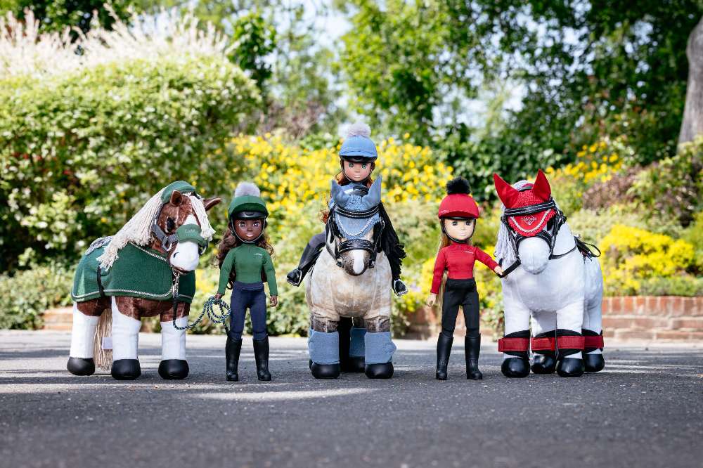 Three LeMieux Rider Dolls with horses displayed outside