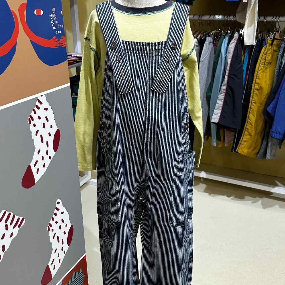 A pair of children's navy striped dungarees on a mannequin at Pitti Bimbo 101 