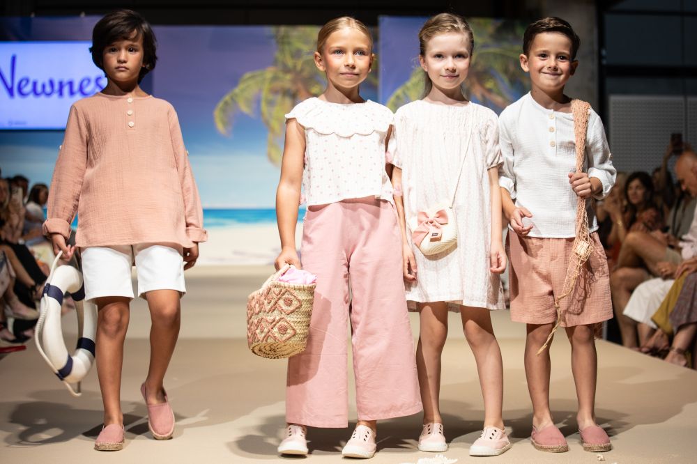 A group of children stood on a stage participating in FIMI Kids Fashion Week