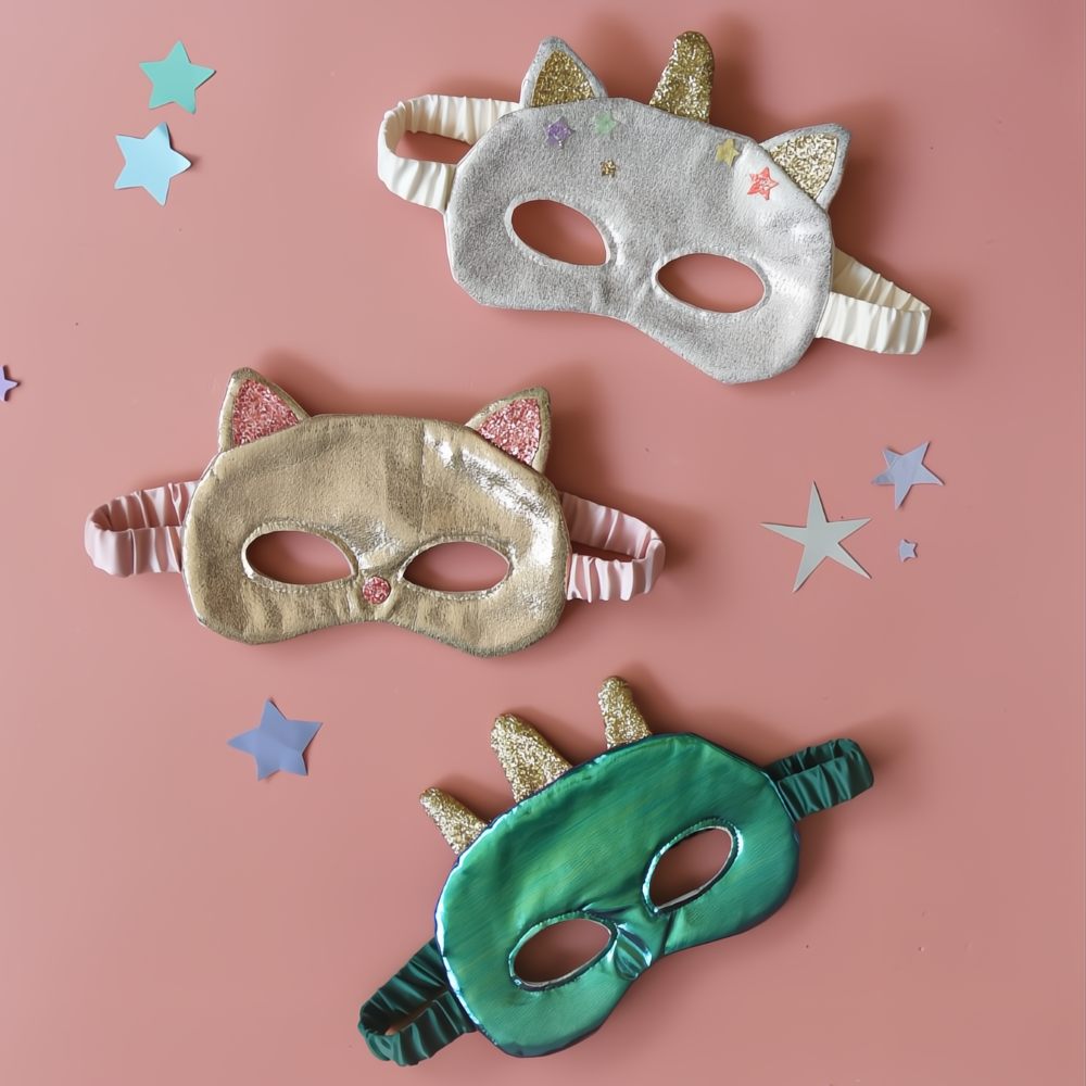 Children's face masks from the Rockahula Kids Dress Up collection displayed on a pink background with stars 