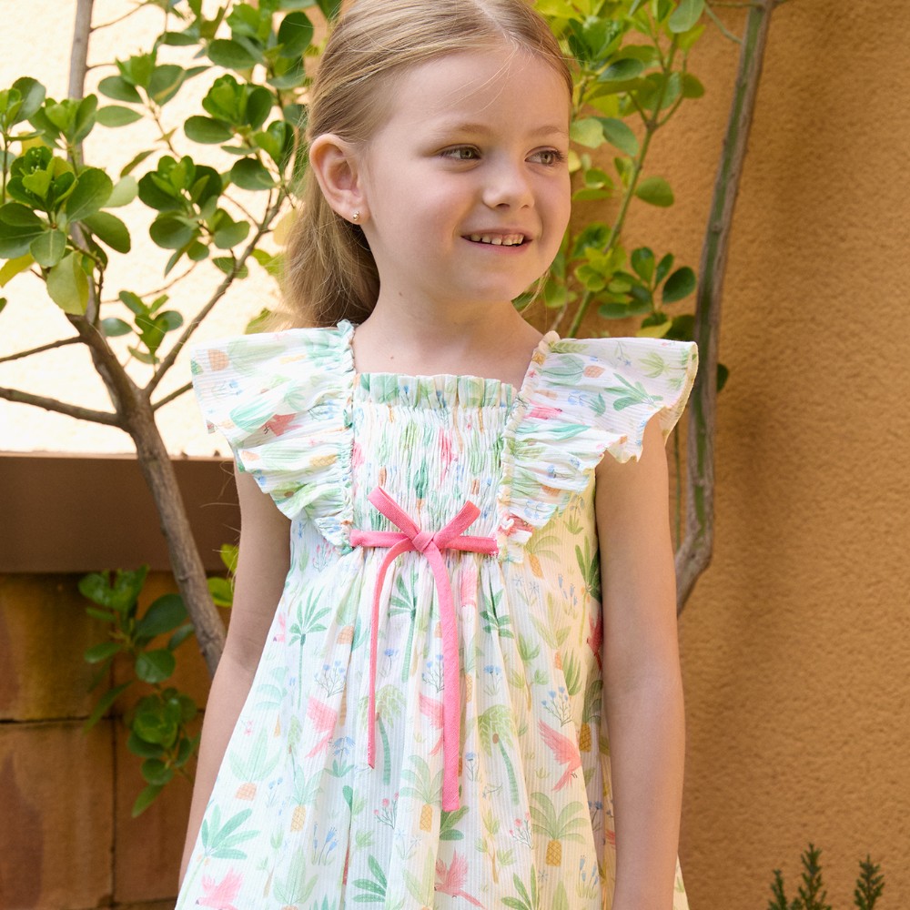 A girl stood outside wearing a floral summer dress 