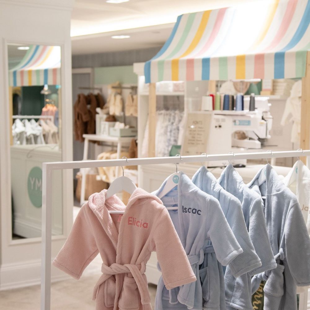 Children's robes displayed on a rail in the My 1st Years concession in Harrods 