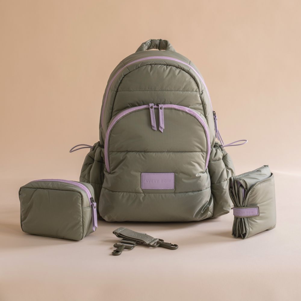 An olive green changing backpack with lilac detailing by Avery Row 