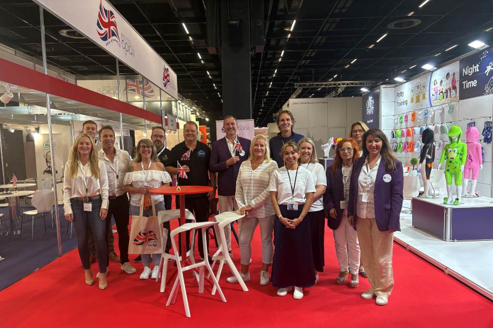 A group of people stood in the BPIA UK Pavilion at Kind + Jugend