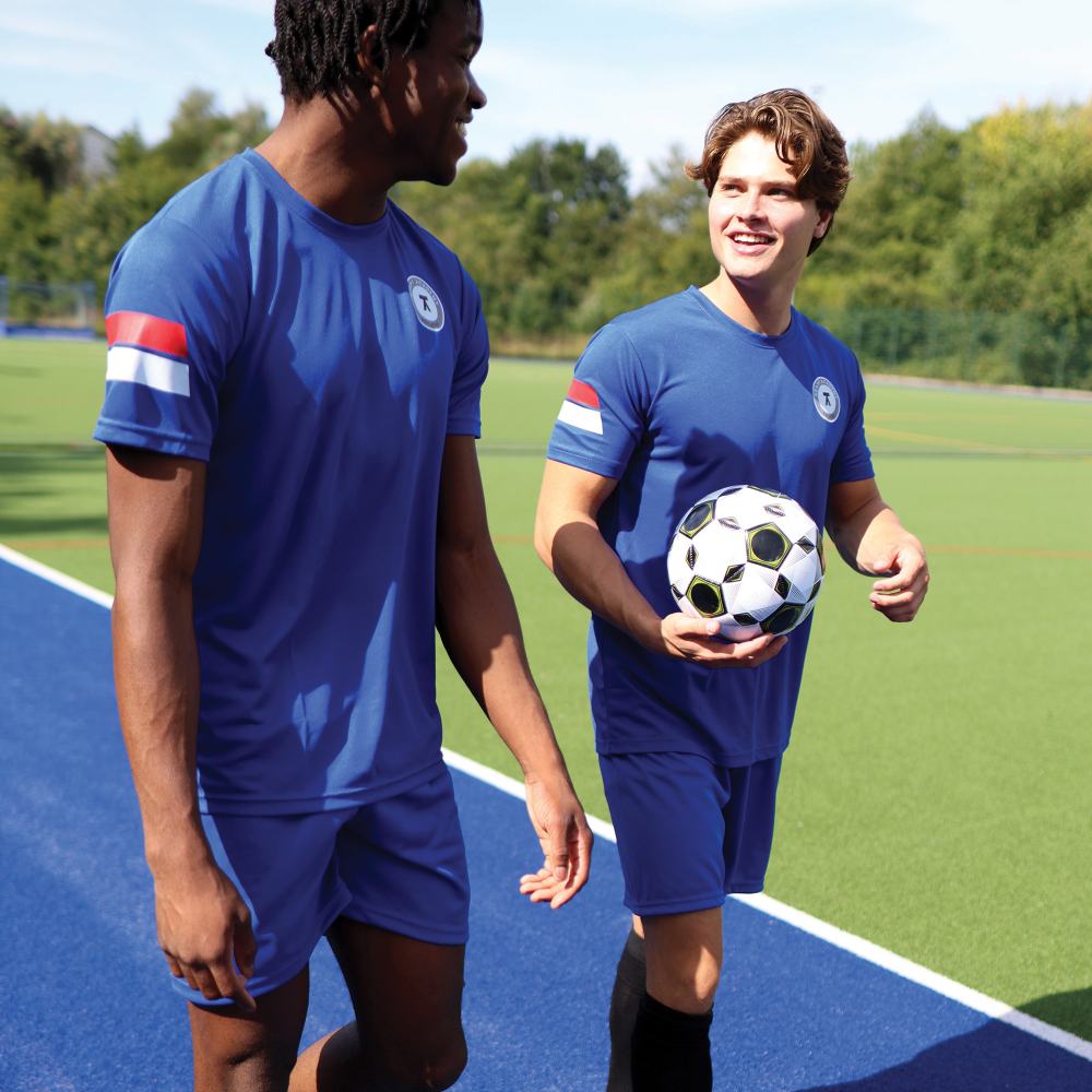 Two people outside wearing blue sportswear kit by Banner 
