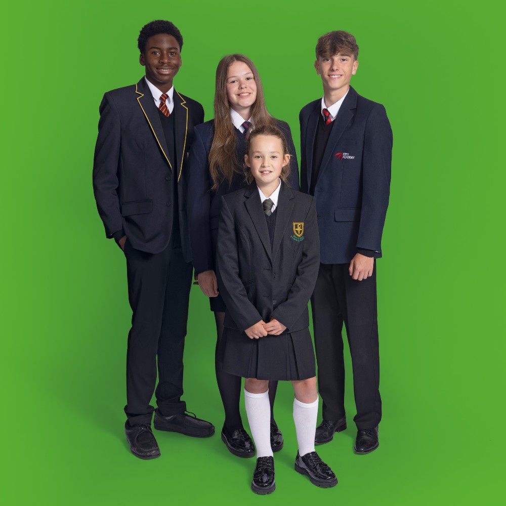 Four children stood against a green background wearing school uniform by One+All 