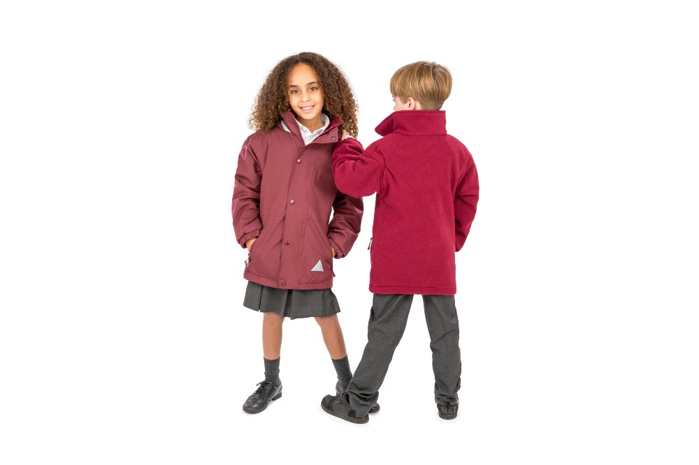 wo children wearing maroon school jackets and school uniforms
