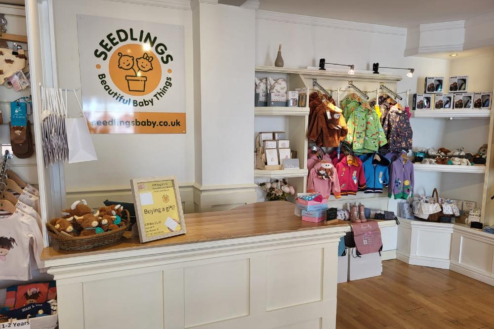 A cash desk and childrenswear displays inside the Seedlings Baby store
