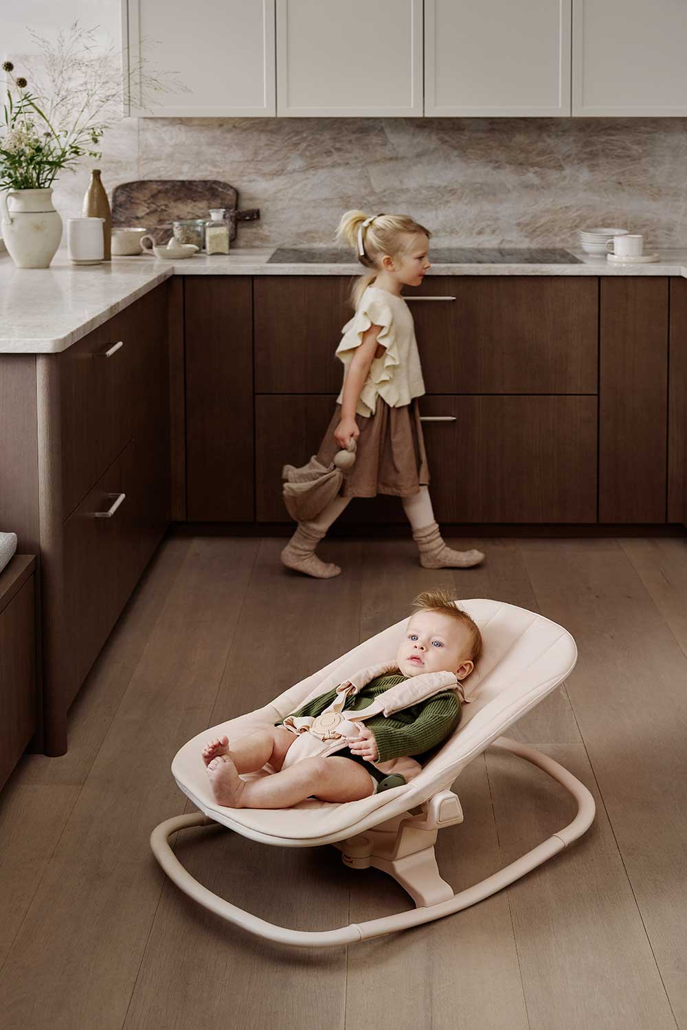 A young baby laid in the Grace Convertible Bouncer Frame