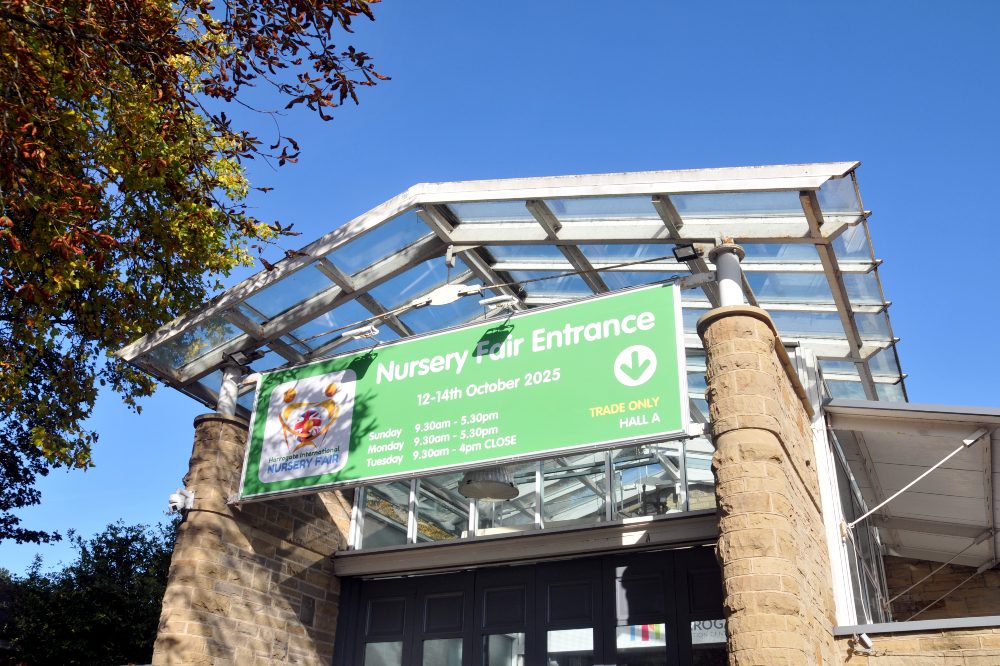 The outside entrance of Harrogate International Nursery Fair against a sunny blue sky